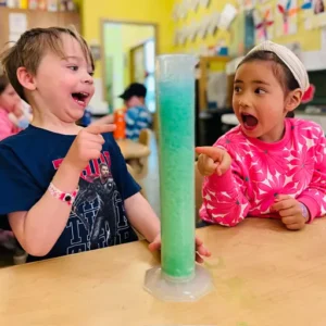 Young scientists exploring chemical reactions in classroom